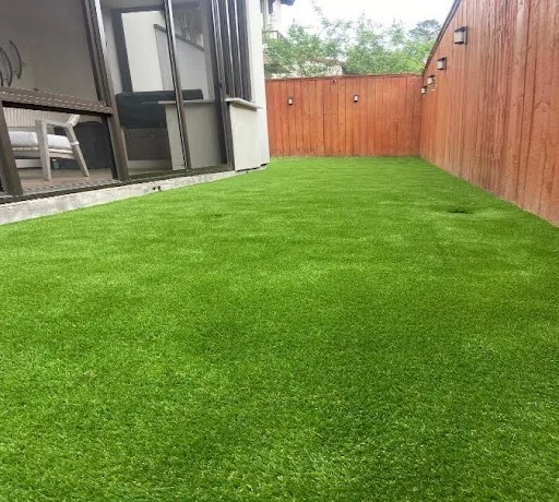 Finished artificial turf lawn in a side yard
